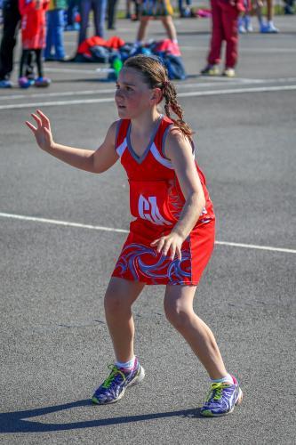 Young girl playing netball ready to catch a ball - Australian Stock Image