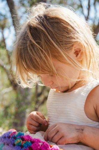 Young girl playing outdoors in a white dress