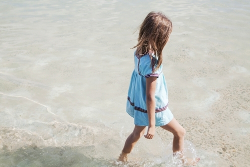 Young girl walking in water