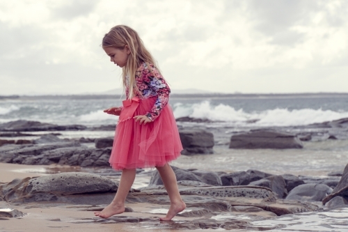 Young girl walking on beach - Australian Stock Image