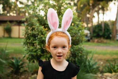 Young girl wearing Easter bunny ears - Australian Stock Image