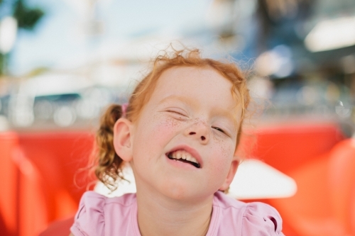 Young girl winking - Australian Stock Image