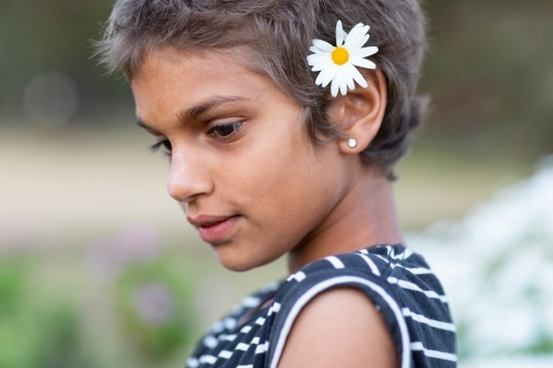 young girl with daisy in her hair - Australian Stock Image