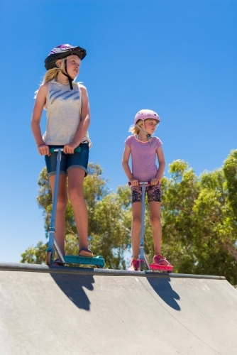 Young Girls On Scooters at Skate Park - Australian Stock Image