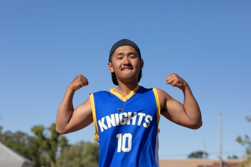 young guy flexing his muscles and being fierce - Australian Stock Image
