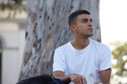 Young Indigenous Australian man enjoying time outdoors - Australian Stock Image