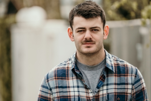 young man walking in street. - Australian Stock Image