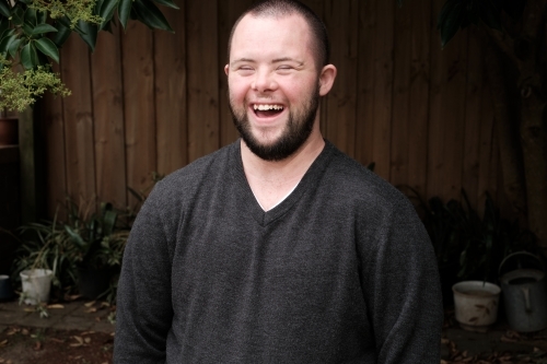 Young Man with Down Syndrome Laughing Heartily - Australian Stock Image
