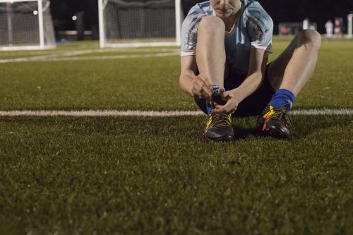 Young teen boy preparing to do evening soccer training - Australian Stock Image