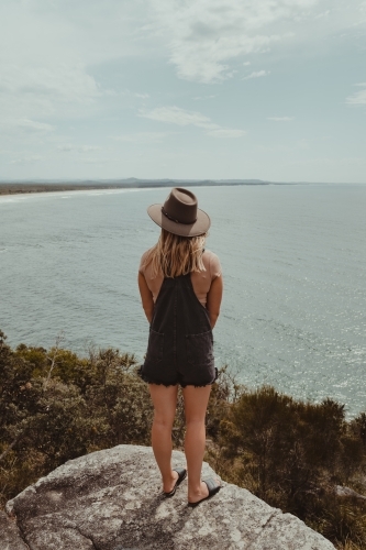 Young woman at a lookout overlooking the beach and ocean at Evans Head. - Australian Stock Image