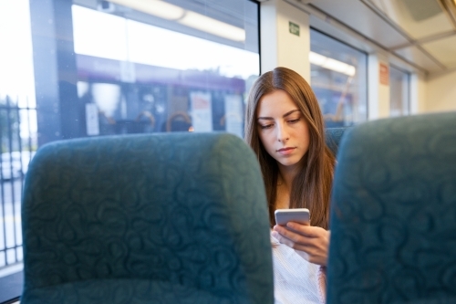 Young Woman Commuting on the Train - Australian Stock Image