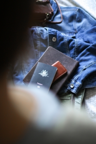 Young woman packing her bag ready to travel - Australian Stock Image
