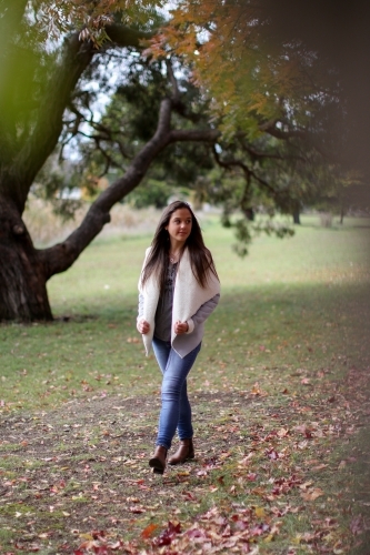 Young woman walking alone outdoors in nature - Australian Stock Image