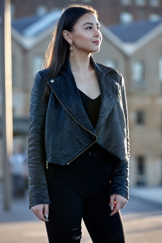 Young woman wearing leather jacket - Australian Stock Image