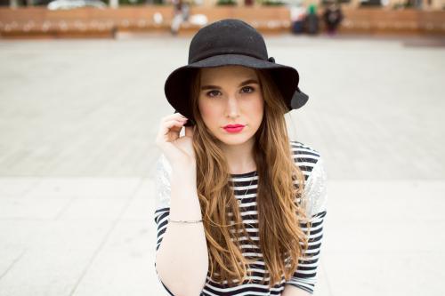 Young woman wearing striped top and hat - Australian Stock Image