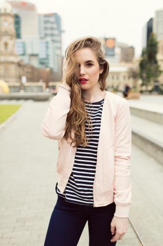 Young woman with striped shirt posing in the city - Australian Stock Image